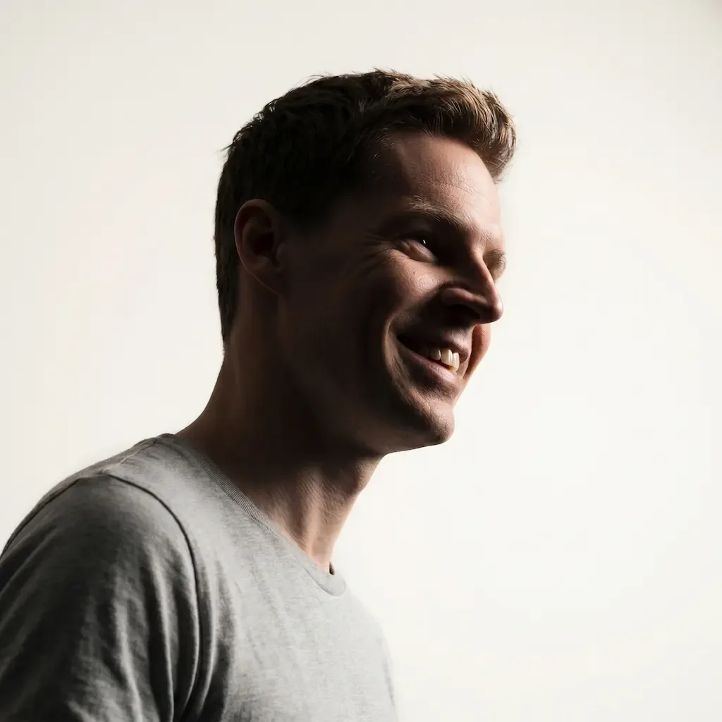 Tom smiling in warm side light.