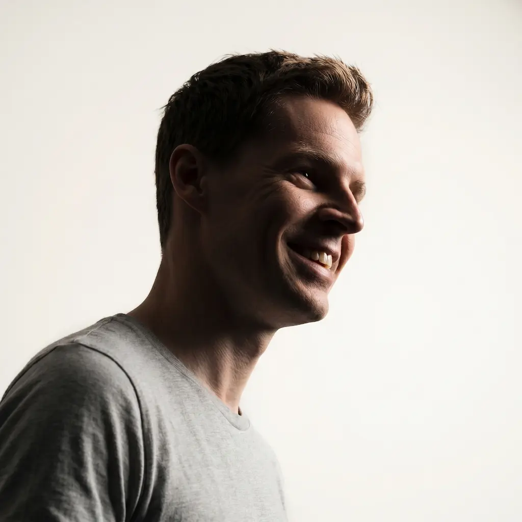 Tom smiling in warm side light.